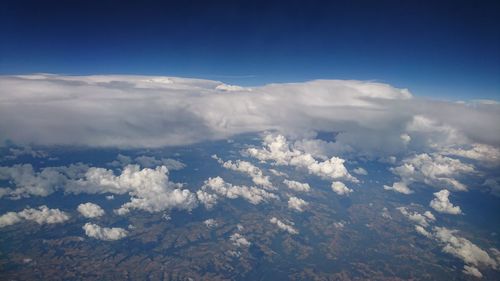 Aerial view of snowcapped mountains against sky