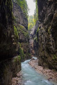 Scenic view of river flowing through rocks