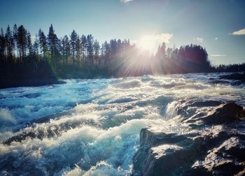 Scenic view of waterfall against sky during winter