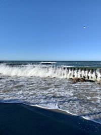 Scenic view of sea against clear blue sky