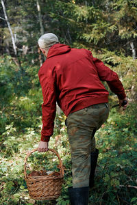 Rear view of man walking on field