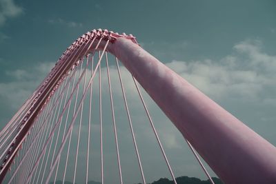 Low angle view of suspension bridge against sky