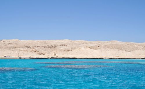 View of calm sea in front of sea against clear sky