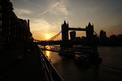 View of bridge over river at sunset