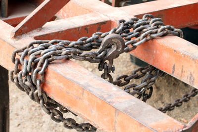 Close-up of chain tied up on rusty metal