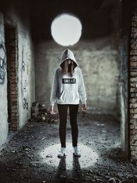 Woman standing in corridor