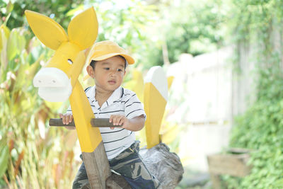 Cute boy sitting on rocking horse