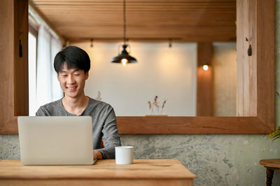 Young woman using laptop at home