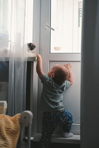 Portrait of boy playing with cat