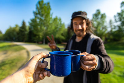 Mid adult man holding coffee cup