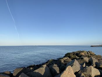 Scenic view of sea against clear blue sky