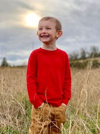 Portrait of a smiling boy standing on field