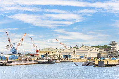 Commercial dock by sea against sky