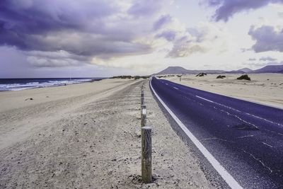 Road by sea against sky