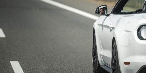 Close-up of car on road