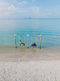 People on beach against sky