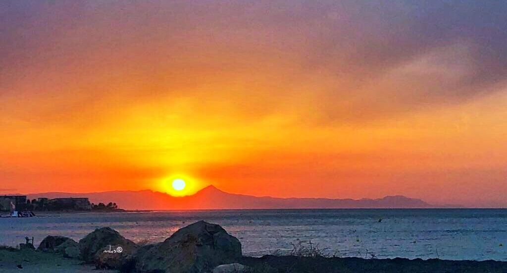 sunset, sky, beauty in nature, scenics - nature, water, sea, tranquility, orange color, tranquil scene, dramatic sky, nature, cloud - sky, land, no people, mountain, idyllic, beach, horizon, sun, outdoors, horizon over water, romantic sky