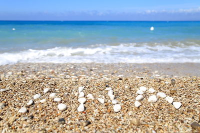 Close-up of sand on beach against sky