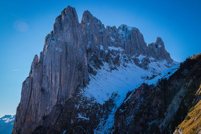 Scenic view of snowcapped mountains against clear blue sky