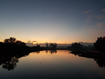 Scenic view of lake against sky during sunset