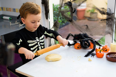 Portrait of boy eating food at home