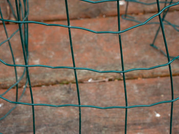 Full frame shot of metal fence against wall