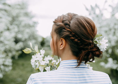 Portrait of woman with red flower