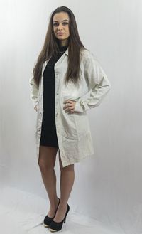 Portrait of young woman standing against wall