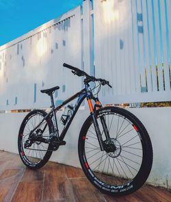 Bicycle parked against wall