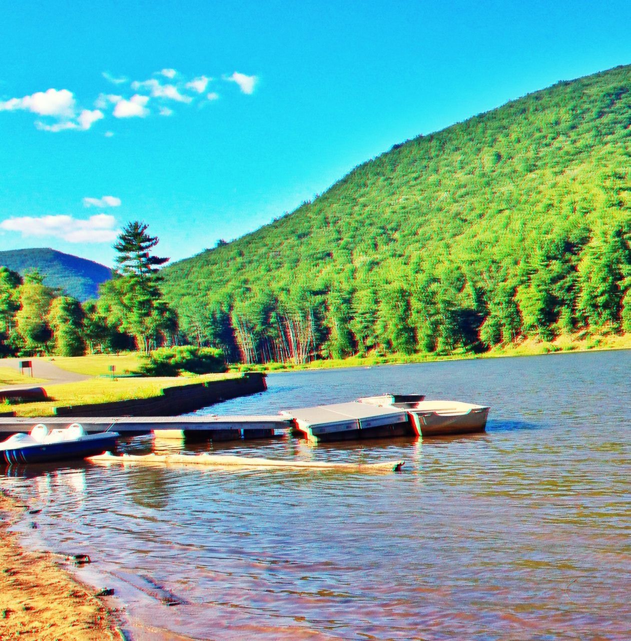 water, nautical vessel, mountain, boat, tranquil scene, lake, tranquility, tree, transportation, scenics, nature, beauty in nature, waterfront, mode of transport, sky, moored, bird, day, idyllic, blue