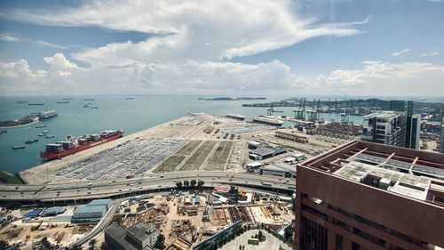 High angle view of buildings against cloudy sky