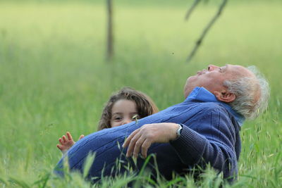 Rear view of two people on field
