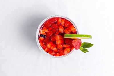 High angle view of fruits in bowl against white background