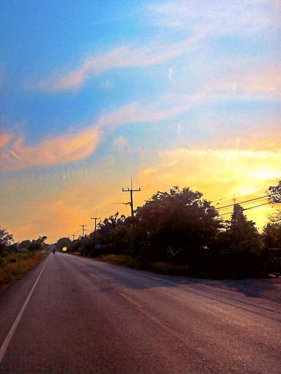 the way forward, road, transportation, sky, sunset, diminishing perspective, vanishing point, road marking, cloud - sky, electricity pylon, empty road, country road, power line, tree, cloud, orange color, street, connection, empty, landscape