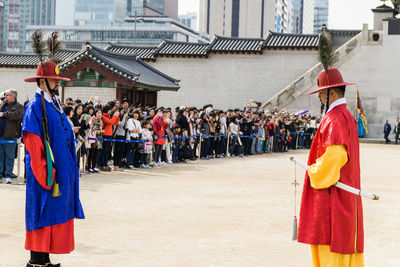 People in front of traditional building