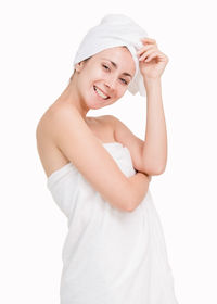 Portrait of a smiling young woman against white background