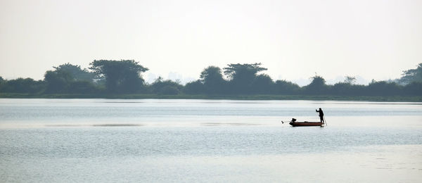 Man on boat against clear sky