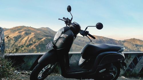 Motorcycle on road against sky