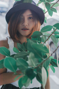 Portrait of young woman wearing hat