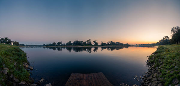 Scenic view of lake against sky during sunset