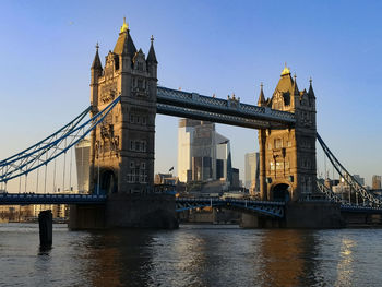 Bridge over river with city in background