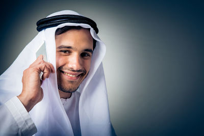 Close-up portrait of a young man using smart phone
