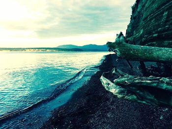 Scenic view of sea against cloudy sky
