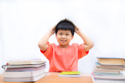 Portrait of boy sitting on table