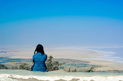 Rear view of woman on beach