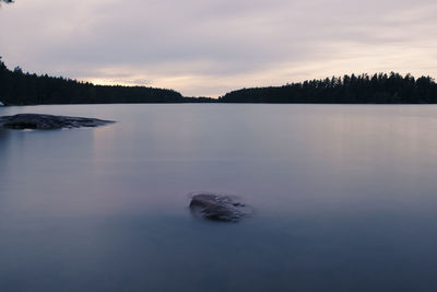 Scenic view of lake against sky during winter