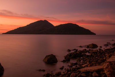 Scenic view of sea against romantic sky at sunset