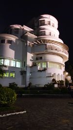 Low angle view of illuminated building against sky at night