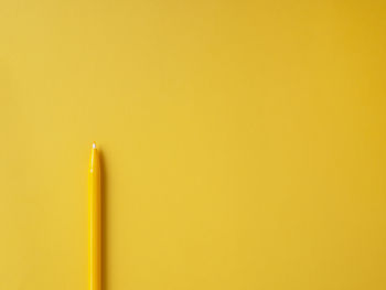 Close-up of pencils against yellow background