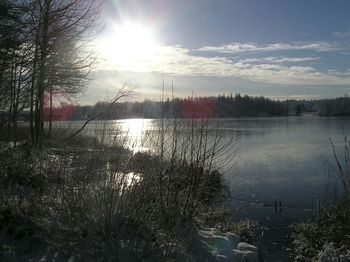 Scenic view of river against sky at sunset